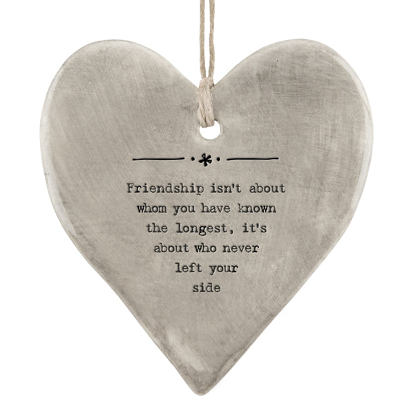 East of India Rustic Hanging Heart which reads:  'Friendship isn't about whom you have known the longest, its about who never left your side.'   The heart shaped hanger also features illustrations in East of India's unique style.