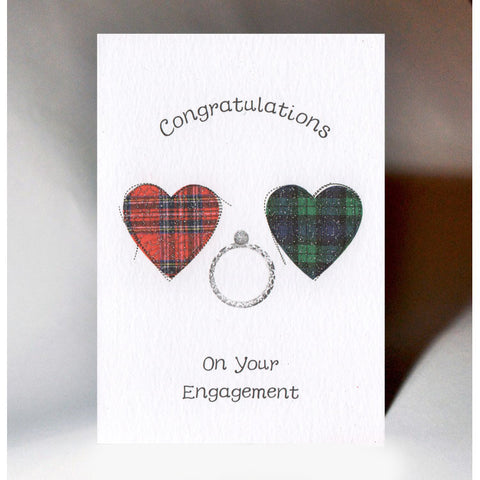  ***Price Includes Delivery ***  Scottish Engagement Card with two tartan hearts and the words;  'Congratulations on Your Engagement'.   Blank inside  Designed and printed in Scotland  Textured White Card, filigree style glitter print  Dimensions: 10.5cm x 15cm  We can send direct to recipient free of charge including a handwritten message inside .... simply add a note to your order (from cart page) including your message.  