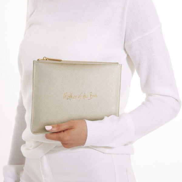 This eye catching Perfect Pouch from much loved brand Katie Loxton comes in a metallic gold colour with the added sentiment in gold, handwritten style 'Mother of the bride'.