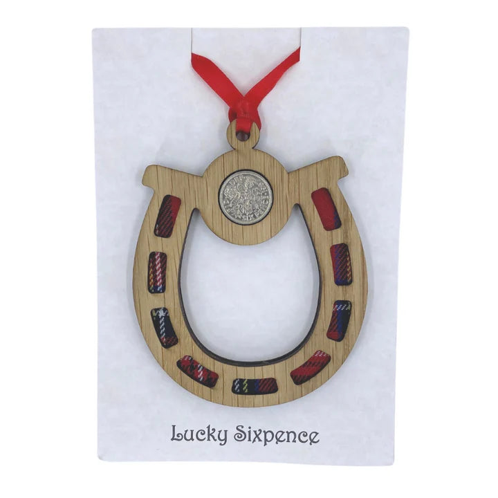 Wooden cut out horseshoe with tartan insert and lucky sixpence with ribbon for hanging.