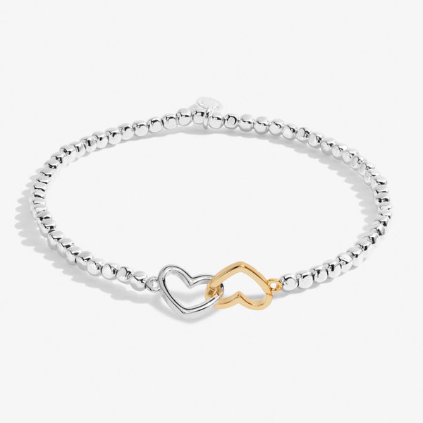 Silver beaded bracelet with silver and gold heart charm