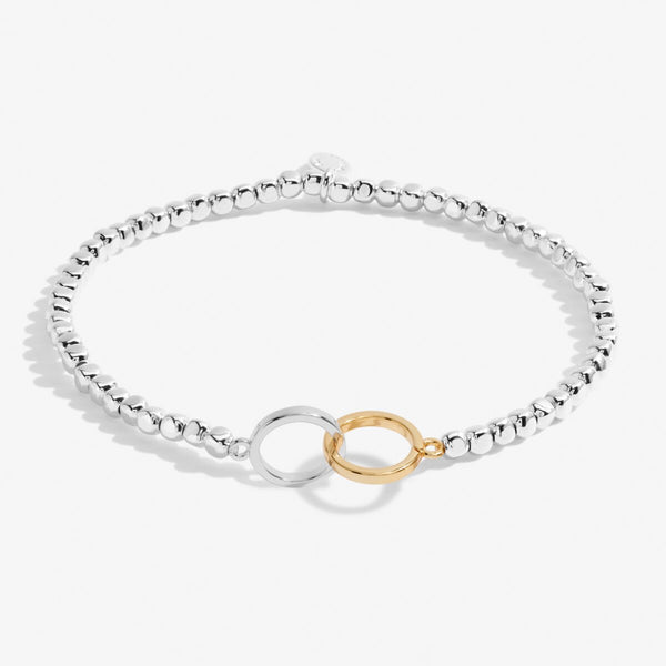 silver bracelet with gold and silver circle charm