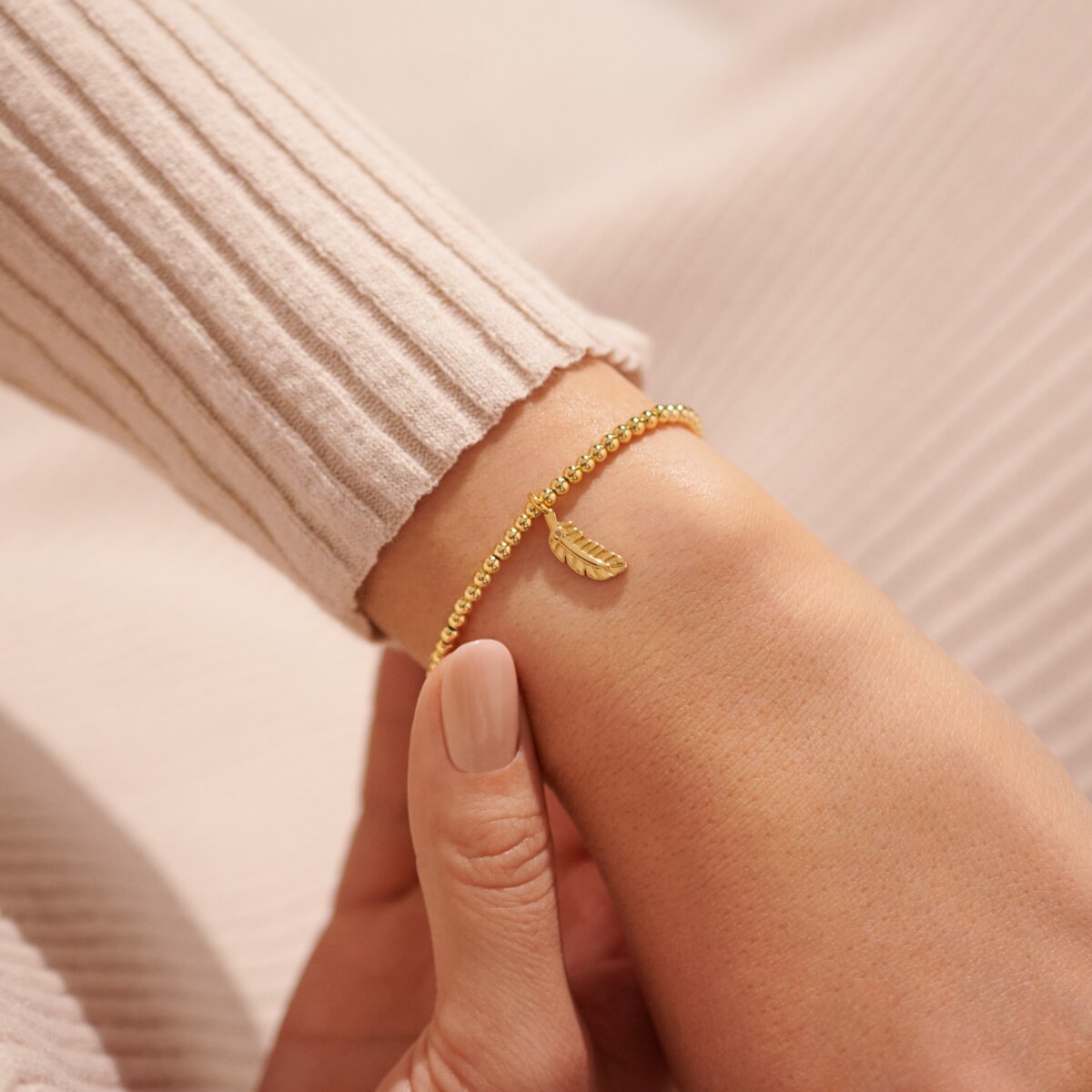 Gold plated Joma jewellery bracelet with hanging feather charm
