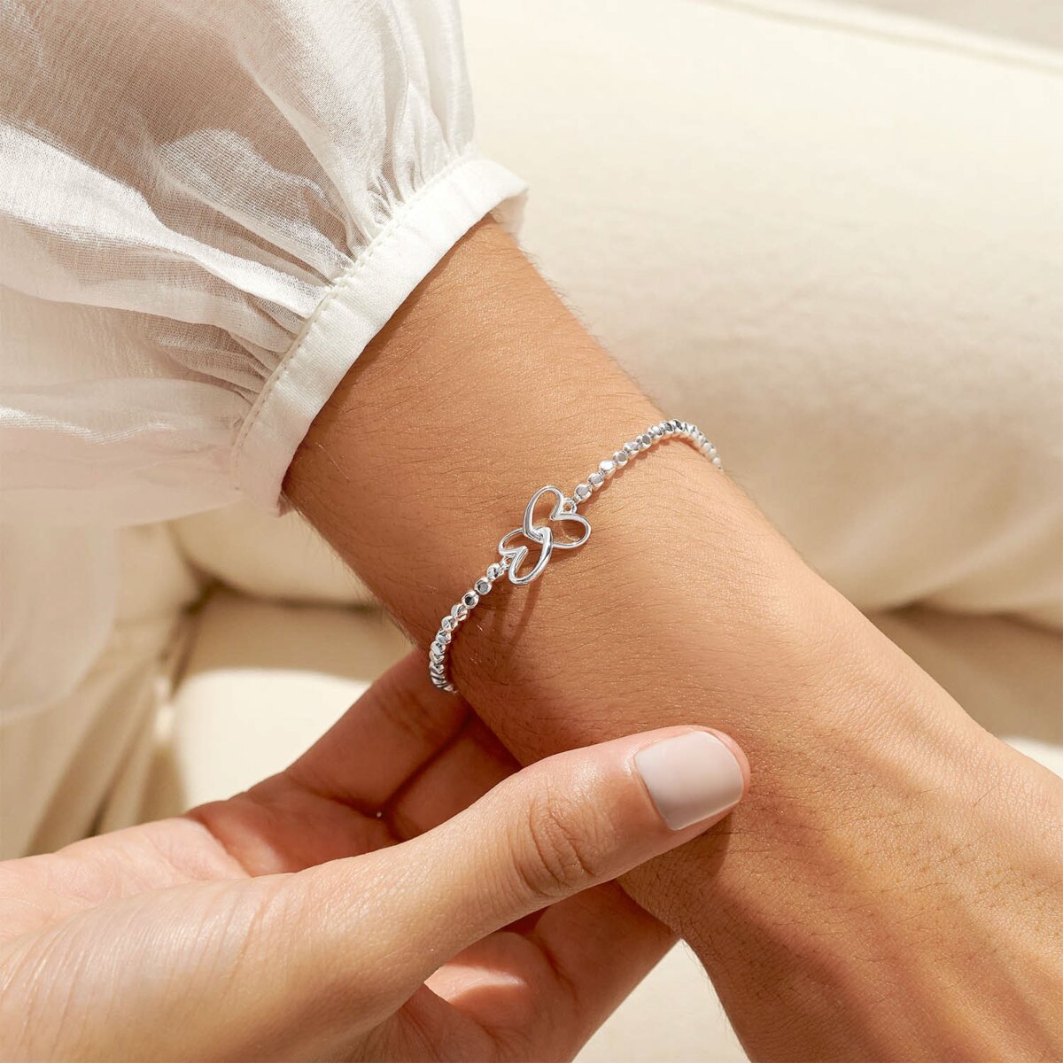 Silver plated beaded stretch bracelet with heart charm