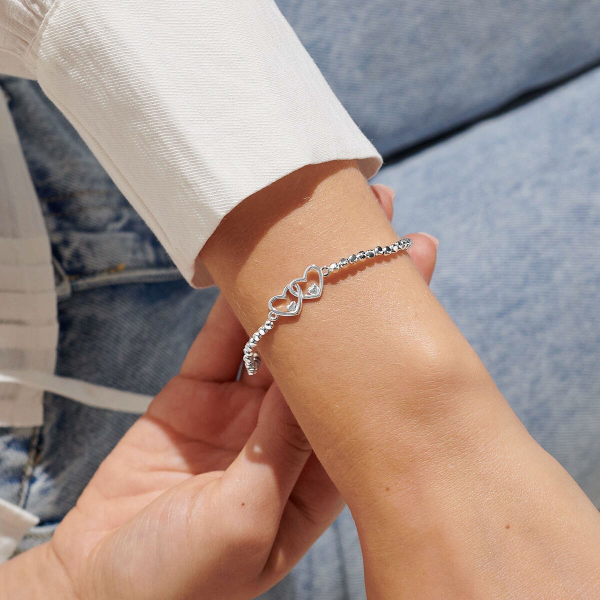 Silver plated beaded stretch bracelet with heart charm