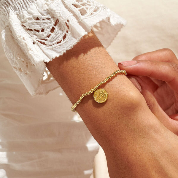 Gold plated beaded bracelet with charm