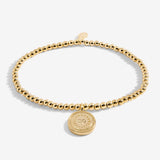 Gold plated beaded bracelet with charm