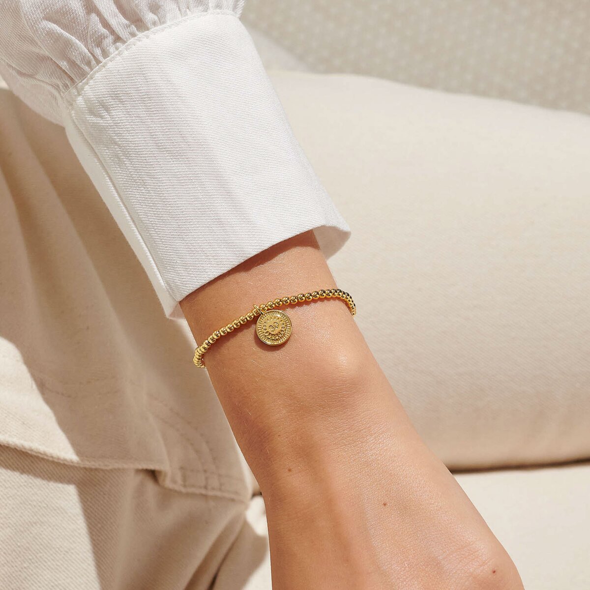Gold plated beaded bracelet with charm