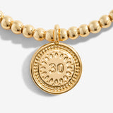Gold plated beaded bracelet with charm