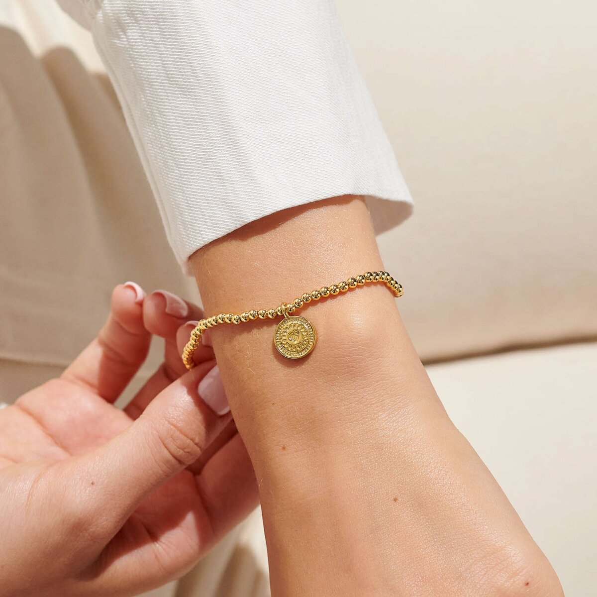 Gold plated beaded bracelet with charm