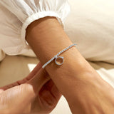 Silver plated beaded stretch bracelet with ring charm