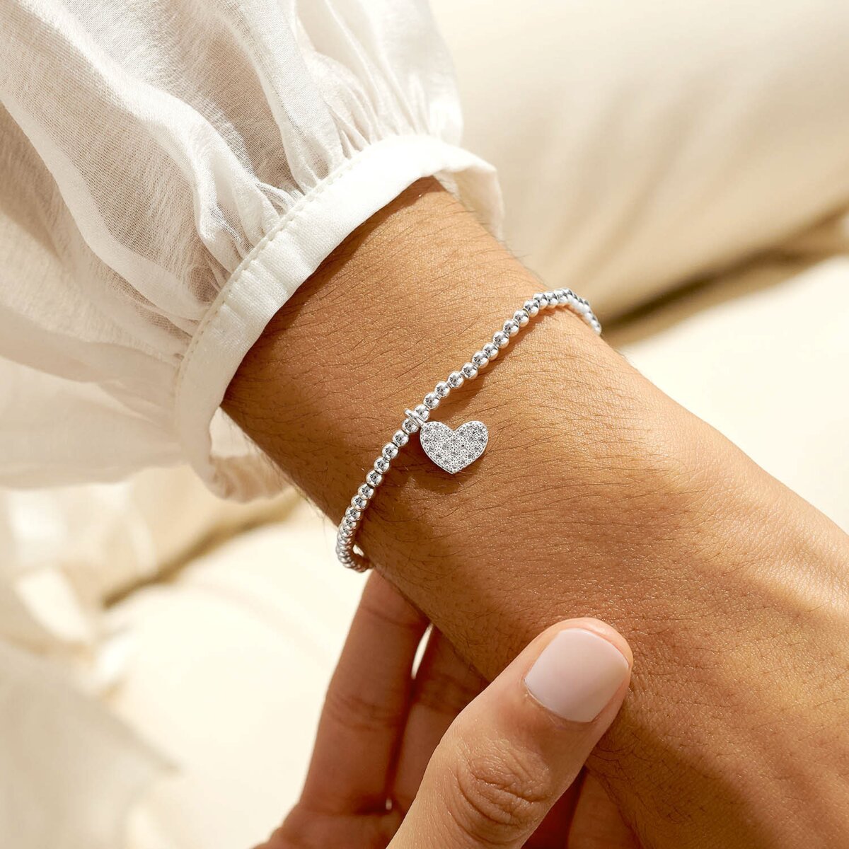 Silver plated beaded stretch bracelet with heart charm