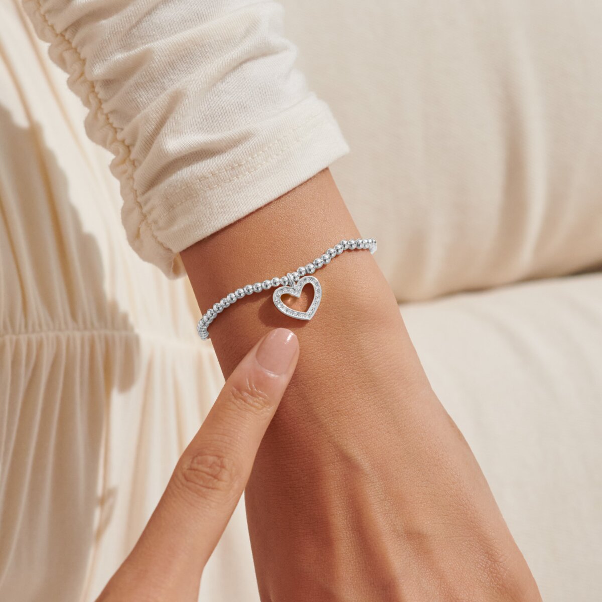 Silver plated beaded stretch bracelet with heart charm