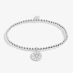 Joma beaded stretch bracelet with heart and disc charm