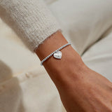 Silver plated 'Sending Love' stretch beaded Joma jewellery bracelet with hanging heart envelope charm on foil stamped sentiment card.
