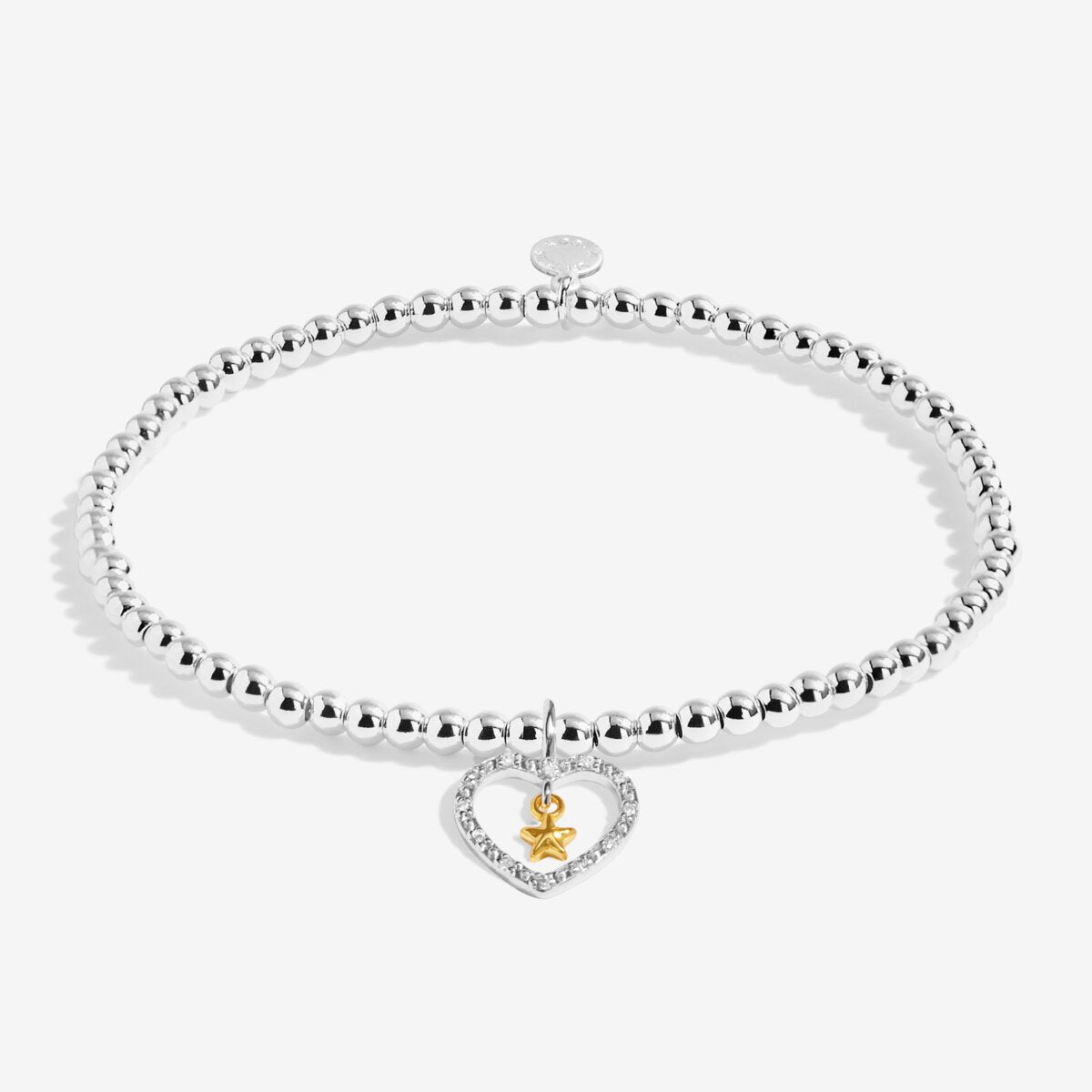 Joma Jewellery bracelet with open sparkling heart charm with hanging gold star on a white foil stamped sentiment card.