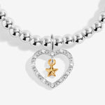 Joma Jewellery bracelet with open sparkling heart charm with hanging gold star on a white foil stamped sentiment card.