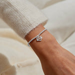 Joma jewellery stretch beaded bracelet with hanging heart infinity charm presented on a foil stamped sentiment card.