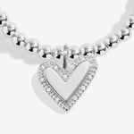 Joma jewellery beaded stretch bracelet with hanging heart charm with sparkle detail presented on a foil stamped sentiment card.