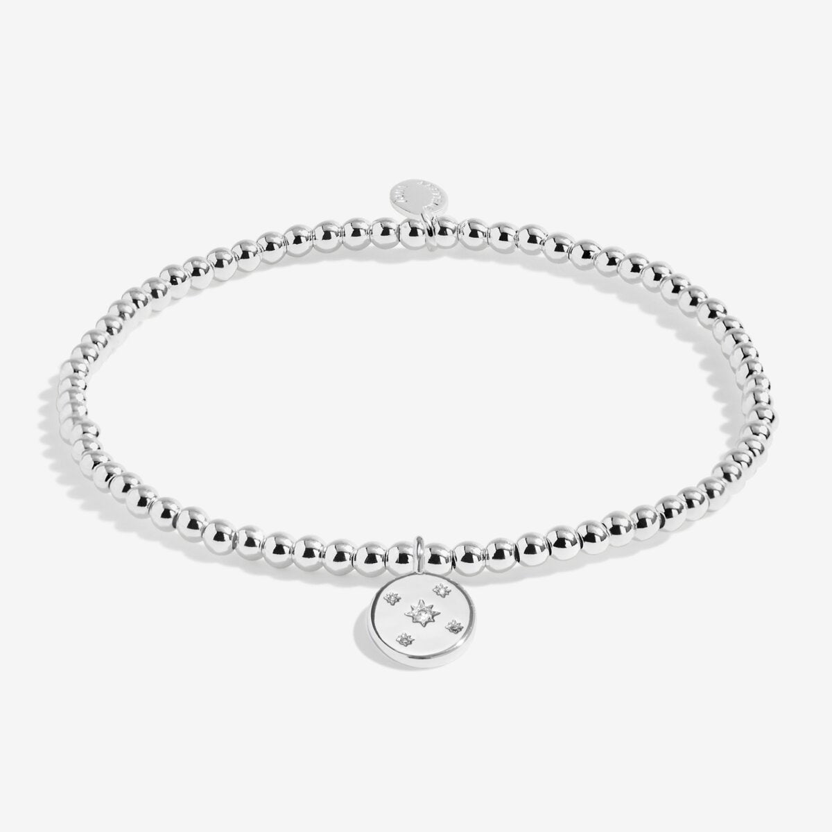 Joma jewellery beaded stretch bracelet with hanging solid disc charm with engraved sparkly stars presented on foil stamped sentiment card.