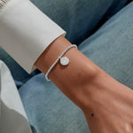 Joma jewellery beaded stretch bracelet with hanging solid disc charm with engraved sparkly stars presented on foil stamped sentiment card.