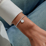 Joma jewellery beaded stretch bracelet with hanging solid disc charm with engraved sparkly stars presented on foil stamped sentiment card.