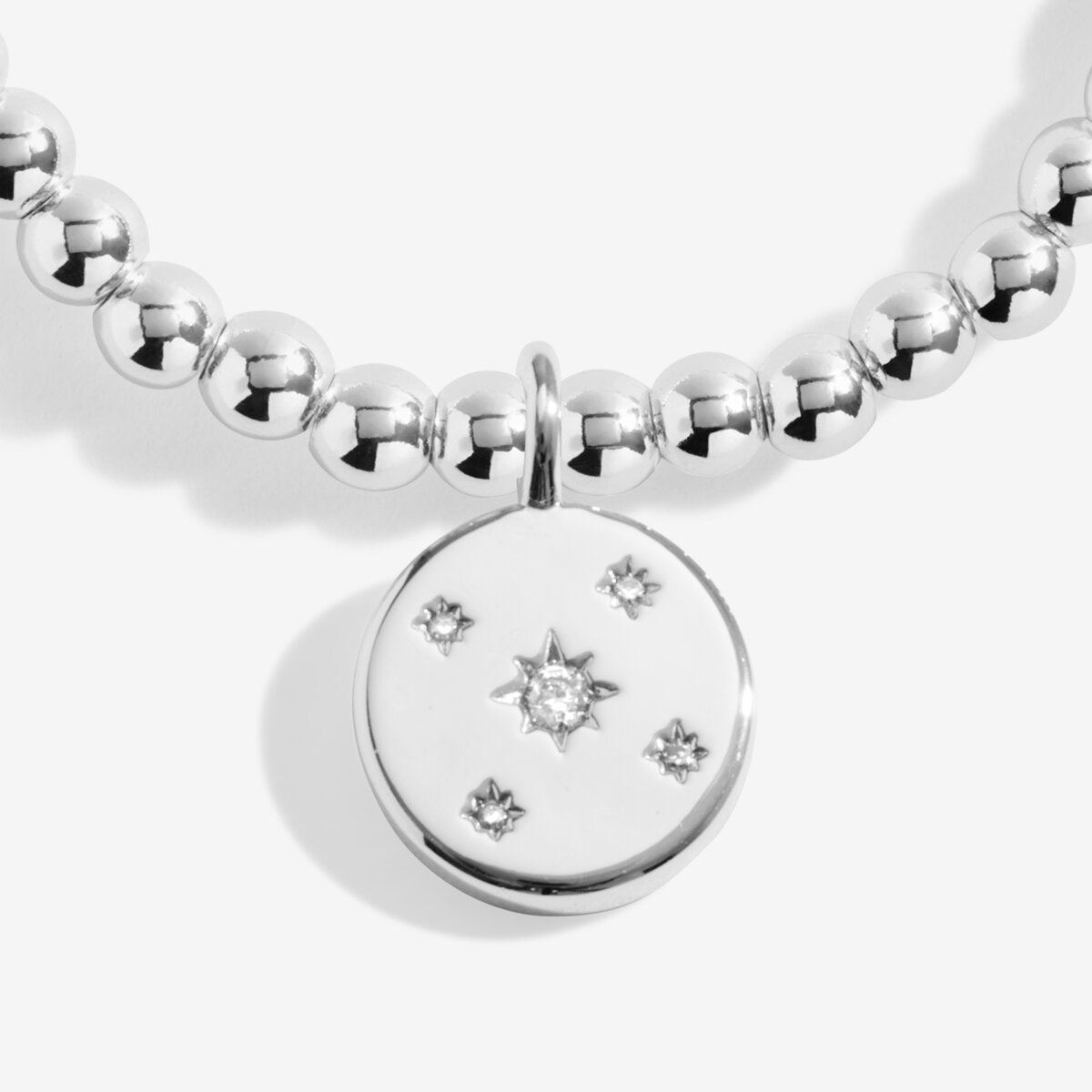 Joma jewellery beaded stretch bracelet with hanging solid disc charm with engraved sparkly stars presented on foil stamped sentiment card.