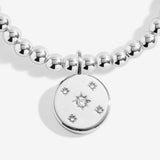 Joma jewellery beaded stretch bracelet with hanging solid disc charm with engraved sparkly stars presented on foil stamped sentiment card.