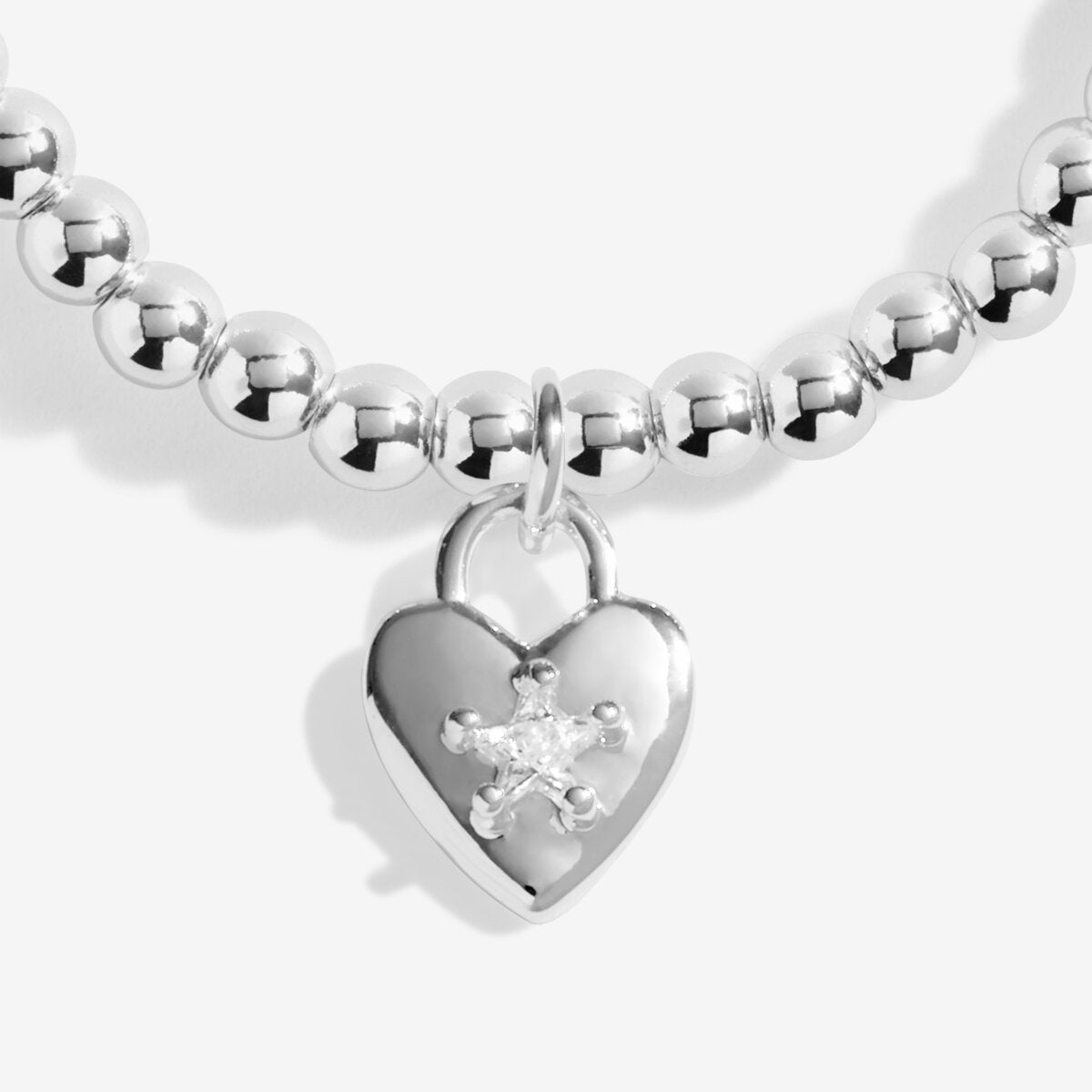 Joma Jewellery beaded stretch bracelet with padlock style heart charm with sparkly star detail presented on foil stamped sentiment card.