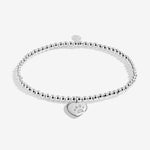 Joma jewellery beaded stretch bracelet with solid heart charm with engraved, textured pawprint presented on a foil stamped sentiment card.