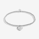 Joma jewellery beaded stretch bracelet with solid heart charm with engraved, textured pawprint presented on a foil stamped sentiment card.
