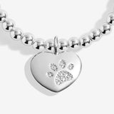 Joma jewellery beaded stretch bracelet with solid heart charm with engraved, textured pawprint presented on a foil stamped sentiment card.