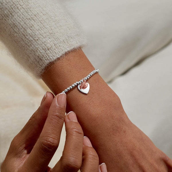Christmas robin Joma Jewellery bracelet presented on festive sentiment card.