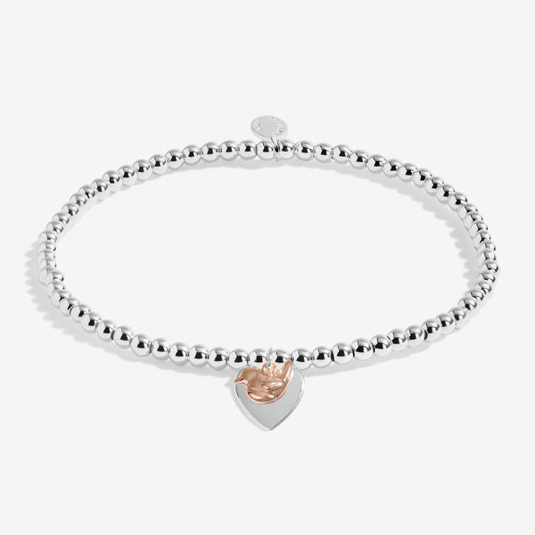 Christmas robin Joma Jewellery bracelet presented on festive sentiment card.