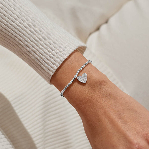 Merry Christmas Lovely Daughter Joma bracelet with silver plated beads and sparkling hanging heart charm.