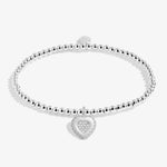 Joma Jewellery stretch beaded bracelet with hanging heart charm with sparkle detail for Gran presented on a foil stamped sentiment card.