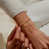 Gold plated Joma Jewellery bracelet with open heart hanging charm with infinity symbol and sparkle detail. Presented on a foil stamped sentiment card.