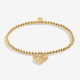 Gold plated Joma Jewellery bracelet for a friend with an open heart hanging charm with sparkle detail. Presented on a foil stamped sentiment card.