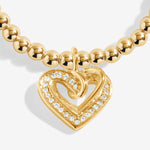 Gold plated Joma Jewellery bracelet for a friend with an open heart hanging charm with sparkle detail. Presented on a foil stamped sentiment card.