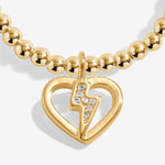 Gold plated Joma Jewellery bracelet with open hanging heart charm with sparkling lightning bolt. Presented on a foil stamped sentiment card.