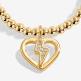 Gold plated Joma Jewellery bracelet with open hanging heart charm with sparkling lightning bolt. Presented on a foil stamped sentiment card.