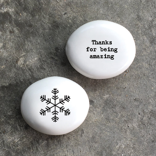 White porcelain pebble with black wording 'Thanks For Being Amazing' on one side and snow flake design on opposite side.
