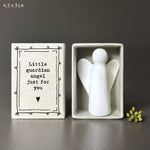 White porcelain angel in cardboard match box