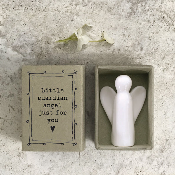 White porcelain angel in cardboard match box