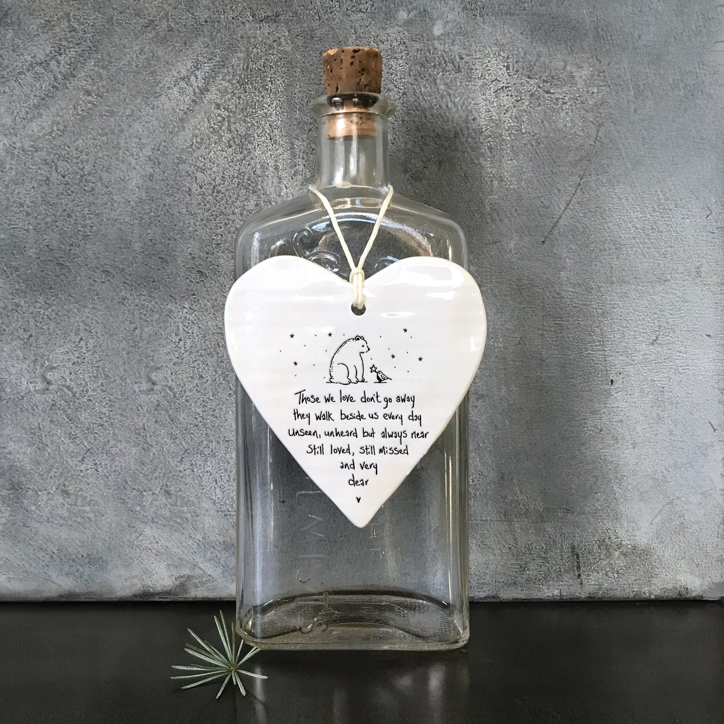 East Of India hanging porcelain wobbly heart with signature style saying Those we love don't go away they walk beside us every day. Unseen, unheard but always near still loved, still missed and very dear.