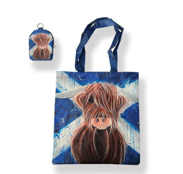 Folding shopper featuring a highland cow illustration in front of a saltire