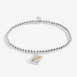 Joma jewellery girls stretch beaded bracelet with hanging book and pencil charm presented on a blush pink sentiment card.