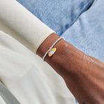 Joma jewellery stretch beaded bracelet with three solid hanging heart charms in silver, gold and rose gold plating presented on a foil stamped sentiment card.