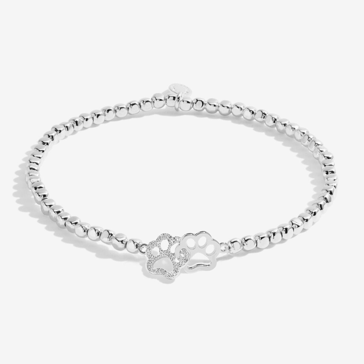 Joma jewellery silver plated stretch beaded bracelet with intertwined paw print charm presented on foil stamped sentiment card.