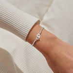 Joma Jewellery stretch beaded silver plated bracelet with intertwined star charm presented on blush pink foil stamped card.